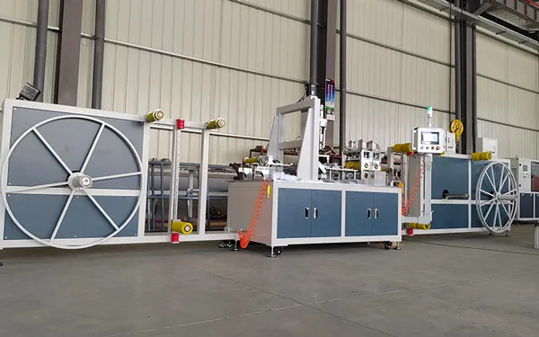 Máquina para fabricación de mangueras planas con salida preinstalada